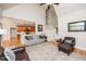 Spacious living room with hardwood floors, vaulted ceilings, and open access to the kitchen at 2100 Stone Pasture Rd, Fuquay Varina, NC 27526