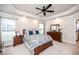 Main bedroom featuring a decorative ceiling fan, large windows, and wood furniture at 2100 Stone Pasture Rd, Fuquay Varina, NC 27526