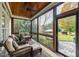 Cozy screened porch with wood ceiling, ceiling fan, and comfortable seating at 2100 Stone Pasture Rd, Fuquay Varina, NC 27526