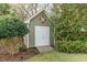 Charming shed with a decorative star accent and double doors, nestled amongst mature landscaping at 2100 Stone Pasture Rd, Fuquay Varina, NC 27526