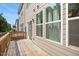 Back deck of home with wood flooring, siding and access to upper deck at 214 George Pine Way, Knightdale, NC 27545