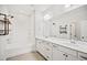 Bright bathroom showcasing double vanity, framed mirror and sleek black plumbing fixtures and shelving details at 214 George Pine Way, Knightdale, NC 27545