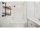 Bright bathroom showcasing tub/shower combo and sleek black plumbing fixtures and shelving details at 214 George Pine Way, Knightdale, NC 27545