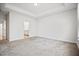 Spacious bedroom with neutral carpeting, tray ceiling, and a large window at 214 George Pine Way, Knightdale, NC 27545