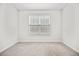 Bright bedroom featuring carpet floors, window, and neutral paint at 214 George Pine Way, Knightdale, NC 27545