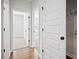 Hallway featuring neutral paint and wood floors, leading to several rooms in the house at 214 George Pine Way, Knightdale, NC 27545