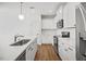 Bright kitchen features white cabinetry, a marble countertop island, and stainless steel appliances at 214 George Pine Way, Knightdale, NC 27545