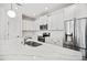 Bright kitchen features white cabinetry, a marble countertop island, and stainless steel appliances at 214 George Pine Way, Knightdale, NC 27545