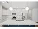 Bright kitchen features white cabinetry, a marble countertop island, and stainless steel appliances at 214 George Pine Way, Knightdale, NC 27545