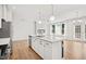 Bright kitchen features white cabinetry, a marble countertop island, and stainless steel appliances at 214 George Pine Way, Knightdale, NC 27545