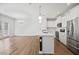 Spacious open-concept living and kitchen area featuring an island, modern appliances, and access to the outdoors at 214 George Pine Way, Knightdale, NC 27545