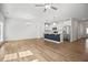 Expansive open-concept living space and kitchen featuring modern lighting, an island, and sleek stainless steel appliances at 214 George Pine Way, Knightdale, NC 27545