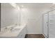 Bathroom featuring double sink vanity, walk-in shower with glass door, and neutral finishes at 228 Palomino Way, Clayton, NC 27520