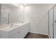 Bright bathroom featuring double sinks with quartz countertops, white cabinetry, and a glass-enclosed shower at 228 Palomino Way, Clayton, NC 27520