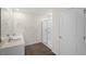 Bathroom featuring double sink vanity, walk-in shower with glass door, and wood-look flooring at 228 Palomino Way, Clayton, NC 27520