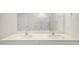 Bathroom featuring double sink vanity, walk-in shower with glass door, and neutral finishes at 228 Palomino Way, Clayton, NC 27520