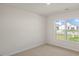 This is a bedroom with carpeted floors and a large window at 228 Palomino Way, Clayton, NC 27520