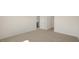 Bedroom featuring neutral carpet, light walls, and a door to the kitchen at 228 Palomino Way, Clayton, NC 27520