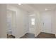 Hallway with wood floors leading to a bathroom and bedroom with natural light and neutral colors at 228 Palomino Way, Clayton, NC 27520
