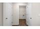 A hallway with wood floors shows doors to storage and a utility room, offering convenient access at 228 Palomino Way, Clayton, NC 27520