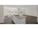 Open-concept kitchen and living area with hardwood floors, granite counters and stainless steel appliances at 228 Palomino Way, Clayton, NC 27520