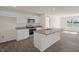 Modern kitchen with white cabinets, stainless steel appliances, granite countertops, and wood-look flooring at 228 Palomino Way, Clayton, NC 27520