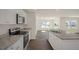 Updated kitchen with granite countertops, stainless steel appliances, white cabinets, and wood-look flooring at 228 Palomino Way, Clayton, NC 27520
