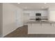 Bright kitchen featuring white cabinetry, granite countertops, stainless steel appliances, and hardwood floors at 228 Palomino Way, Clayton, NC 27520
