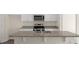 Close up on an island with a double sink, granite countertops, and stainless steel appliances at 228 Palomino Way, Clayton, NC 27520