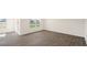 This is a bright living room with wood-look floors and large windows at 228 Palomino Way, Clayton, NC 27520