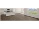 This is a living room and kitchen with wood-look floors and a large window at 228 Palomino Way, Clayton, NC 27520