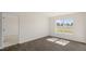 This is a bright living room with wood-look floors and a large window at 228 Palomino Way, Clayton, NC 27520