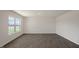 This is a bright living room with wood-look floors and large windows at 228 Palomino Way, Clayton, NC 27520