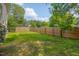 Fenced-in backyard with a well-maintained lawn and a wooden fence at 2312 Shallowford Ln, Chapel Hill, NC 27517
