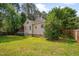 View of backyard highlighting the lawn, privacy fence, trees, and the rear of the house at 2312 Shallowford Ln, Chapel Hill, NC 27517