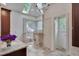 Luxurious bathroom featuring a glass-enclosed shower, granite counters, and skylight at 2312 Shallowford Ln, Chapel Hill, NC 27517