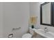 Half bathroom featuring a modern mirror, sink, toilet and towel rack at 2312 Shallowford Ln, Chapel Hill, NC 27517