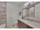 Bathroom with granite vanity, decorative mirror, and tiled walls at 2312 Shallowford Ln, Chapel Hill, NC 27517