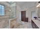 Bathroom with glass shower, granite counters, cabinet, and neutral color palette at 2312 Shallowford Ln, Chapel Hill, NC 27517