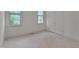 Bright bedroom featuring neutral carpet, two windows, and a double door closet at 2312 Shallowford Ln, Chapel Hill, NC 27517