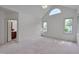 Large bedroom with vaulted ceiling, multiple windows, and neutral carpet at 2312 Shallowford Ln, Chapel Hill, NC 27517