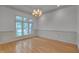 Elegant dining room with hardwood floors, large window, and classic wainscoting at 2312 Shallowford Ln, Chapel Hill, NC 27517