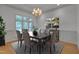 Formal dining room with chandelier, neutral colors and a large window for plenty of natural light at 2312 Shallowford Ln, Chapel Hill, NC 27517
