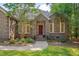 Inviting front entrance with a beautiful red door and manicured landscaping at 2312 Shallowford Ln, Chapel Hill, NC 27517