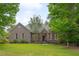Charming brick home featuring a well-manicured lawn and mature trees at 2312 Shallowford Ln, Chapel Hill, NC 27517