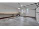 Spacious garage featuring a large workbench, windows and attached storage at 2312 Shallowford Ln, Chapel Hill, NC 27517