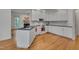 The kitchen has white cabinets, black countertops, and stainless steel appliances at 2312 Shallowford Ln, Chapel Hill, NC 27517
