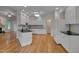 Kitchen features black countertops, white cabinets, and seamlessly connects to the living area at 2312 Shallowford Ln, Chapel Hill, NC 27517