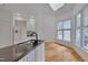 Bright kitchen featuring black countertops, white cabinets, and views of the outdoors at 2312 Shallowford Ln, Chapel Hill, NC 27517