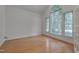 Bright living room with hardwood floors and large arched window at 2312 Shallowford Ln, Chapel Hill, NC 27517
